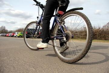 Fototapeta na wymiar Mountain bike, person riding a bicycle, focus on back wheel