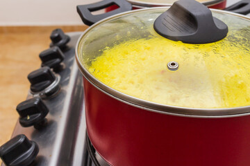 Red pots with food on the stove