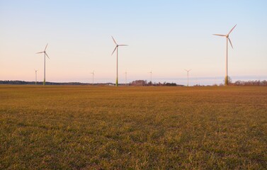 Wind turbine generators, country field at sunset. Concept image, graphic resources, ecology,...