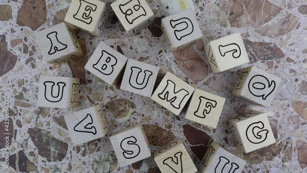 Poster bumf - concept with alphabet letters on wooden blocks arranged to the centre with a frame of random 