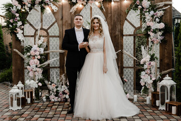 the groom with the bride on the photozone. wedding photo zone. holiday of a young couple.Two hearts...