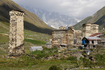 Medieval defensive towers rise above the more recent homes of Ushguli village, Upper Svaneti, Georgia