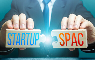 Man connects puzzles with words Startup and SPAC. Simplified fundraising and funding procedure for...