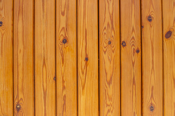 Wooden brown bars. Texture of the light wood boards lie vertically. Wood background