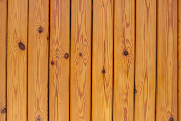 Naklejka premium Wooden brown bars. Texture of the light wood boards lie vertically. Wood background
