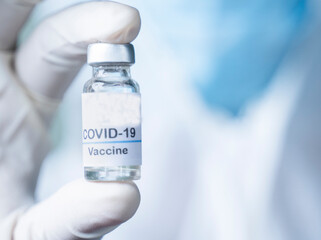 Doctor holding Pfizer Biontech vaccine against coronavirus COVID disease.