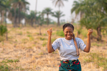 portrait of an excited young female african farmer