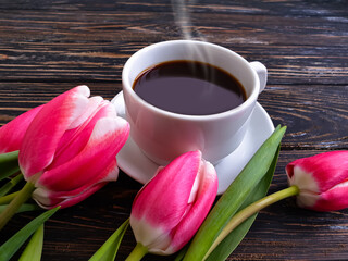 Fototapeta na wymiar cup of coffee flower tulip on wooden background