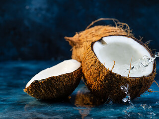 coconuts on a blue background with coconut water in motion.Frost in motion.Fresh photo