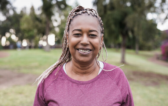 African senior woman smiling in camera at park
