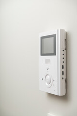 white video intercom on the wall in the apartment, free space