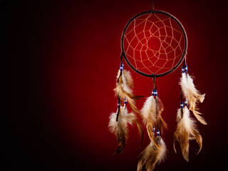 Dreamcatcher on a red background, with space for an inscription. Cultural Amulet, Indian Culture