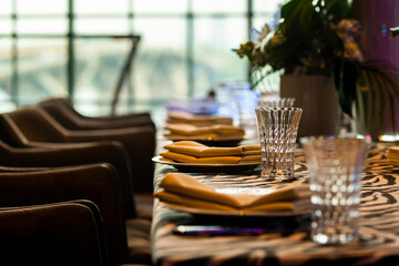 table setting in a restaurant, crystal corrugated glasses with napkins at a banquet
