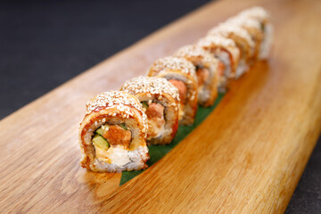 Eel unagi maki sushi rolls on serving board