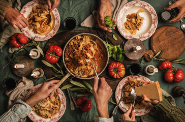 Family eating pasta Bolognese at Italian style dinner