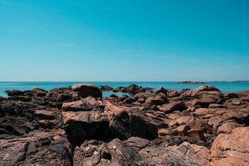 Fototapeta na wymiar Playa de rocas con el mar de fondo