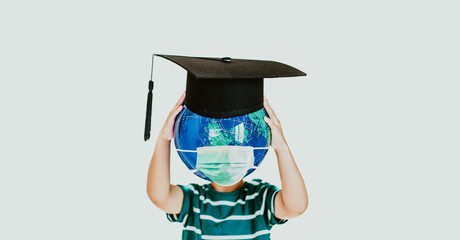 Kid boy student holding globe world with graduate cap mask medical e-learning during covid19 coronavirus, distance learning ,online education.Science, Healthcare, Environment, pollution, student kid.