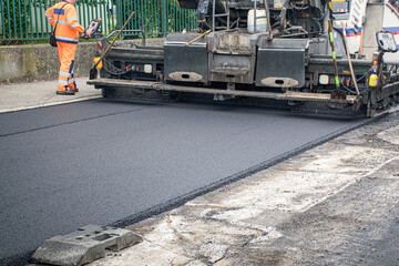 Screed of asphalt paver makes smooth asphalt mat - road reconstruction