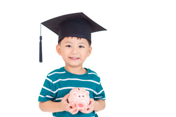 Kid toddler hands holding pink piggy bank, wearing graduation hat isolated on white.Money saving,...