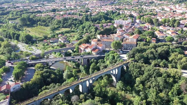 General view from drone of Ceret town on banks of river Tech in foothills of Pyrenees mountains in summer, France