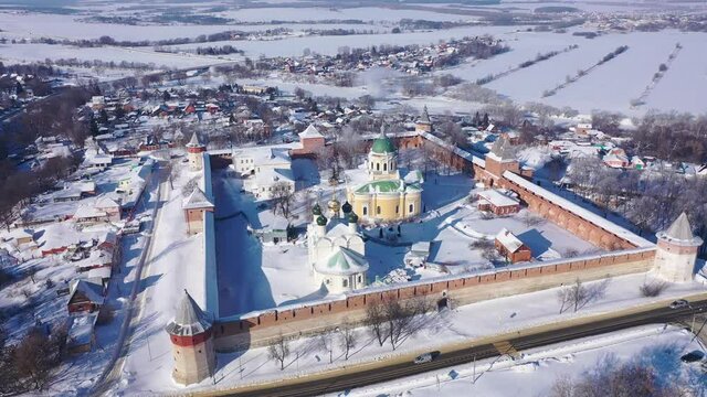 View from drone of snow covered architectural ensemble of Zaraysk Kremlin with Forerunner and St. Nicholas cathedrals on winter day, Russia