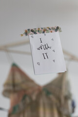 Positive sticky note pasted with a pineapples adhesive strap on a mirror where a blurred woman...