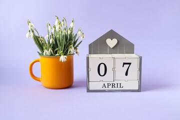 Calendar for April 7: cubes with the numbers 0 and 7, the name of the month of April in English, a...