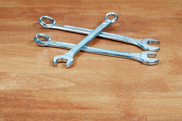 wrench metal three tools of the master on wooden background