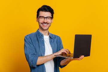 Attractive contented good looking stylish unshaven caucasian guy with glasses holding an open...