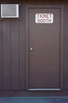 Ticket booth sign on a wooden door