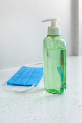 Image of medical surgical mask and sanitizer hand gel.