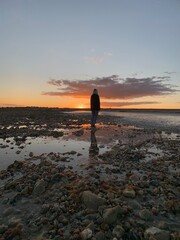 Silhouette of person at sunset on the beach