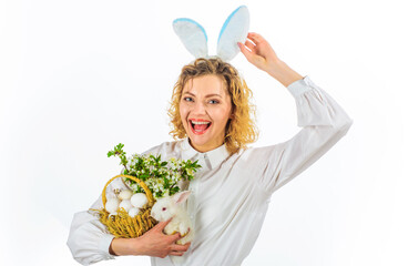 Happy Easter day. Smiling woman with white rabbit and basket with eggs.