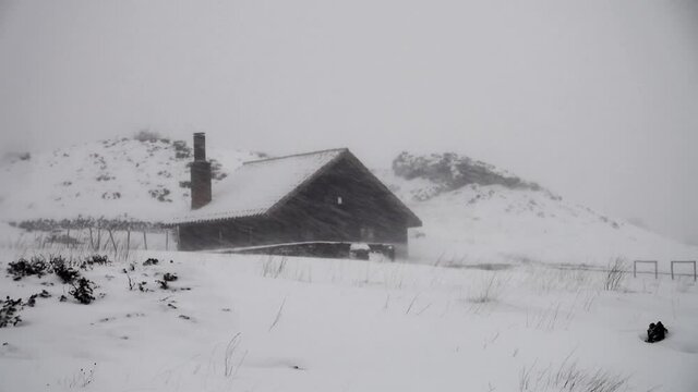 blizzard on a stone refuge in mountains of Sicily severe snow storm with high winds in Etna Park