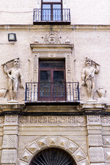 Fototapeta na wymiar balcony with demons of the almodovar building, murcia, spain.