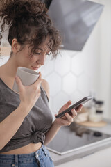 Joyful brunette woman chatting surfing internet use smartphone enjoying coffee break at cafe