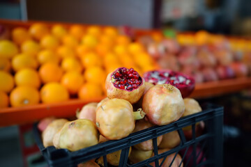 Grocery store showcase with ripe oranges and pomegranates. Street vendor tray with fresh juice....