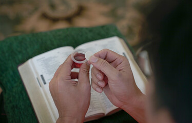 Man holding bread and wine in Hoy Communion.