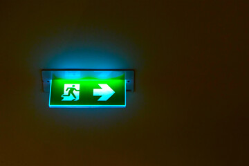 Emergency exit sign on ceiling in the dark