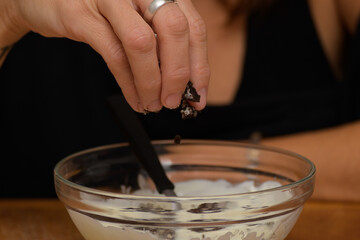 Add two pieces of cookies to melted white chocolate to prepare Easter eggs