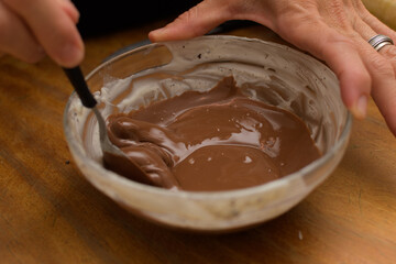 Bowl with melted chocolate to prepare easter eggs