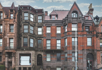Fototapeta na wymiar Street view of an old, red brick apartment building in Philadelphia