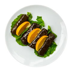 Traditional Turkish sarma from vine leaves filled with rice served with lime and greens. Authentic...
