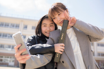 小学校の卒業式に出席する親子