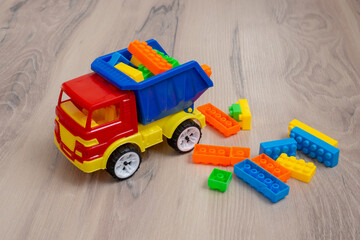 Multi-colored toy truck. Plastic children's toy. Dump truck.