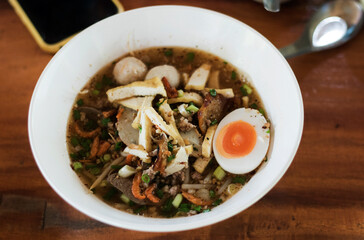 Noodles with meatballs and boiled eggs are a popular Asian dish.