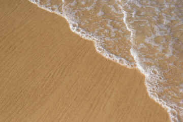 Wave of the sea on the sand beach