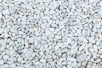 White round pebbles laid on the floor as an image for making the background.