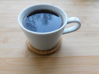 Coffee cup top view on wooden table background.