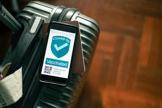 Covid-19 vaccine passport app concept. Vaccinated people bring along the phone with vaccine certificate while traveling. QR code contain the word "vaccinated".